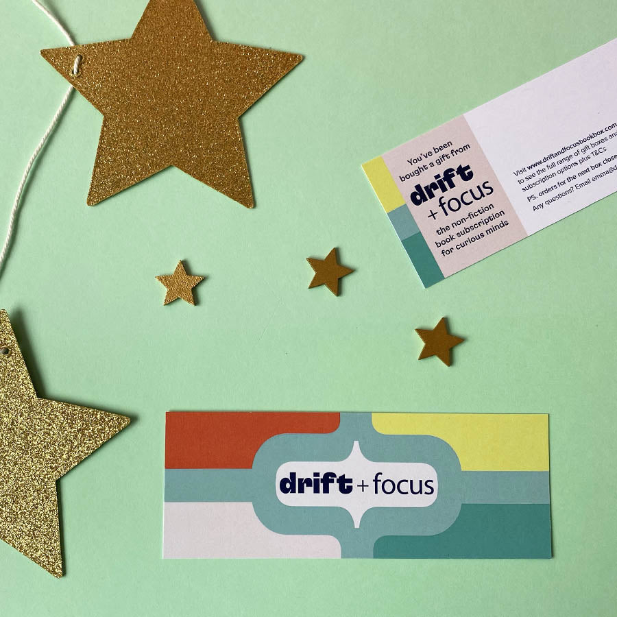 Overhead shot of the front and back of a Drift and Focus bookmark gift card